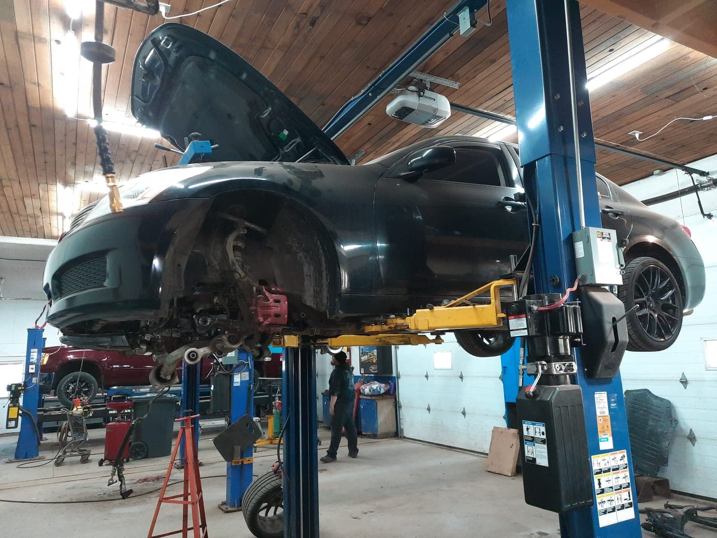 A car raised on the lift in the service bay
